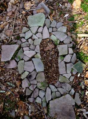 footprint made using found sandstone, c.1ft x 0.5ft, found sandstone